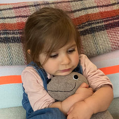 Wool Seal Soft toy being hugged by girl