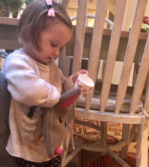little girl putting things in bunny bag by cdbdi