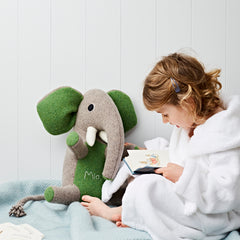 elephant with green ears being read to by cdbdi