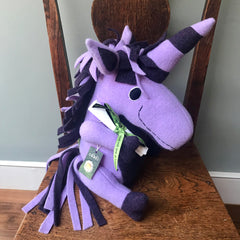 Purple unicorn on chair with scroll by cdbdi