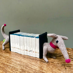 grey dachshund bookends with a pink nose