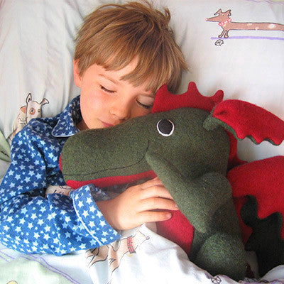 Green and red dragon asleep with small boy by cdbdi